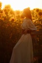 Beautiful woman in a dress in a field of sunflowers Royalty Free Stock Photo