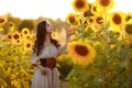 Beautiful woman in a dress in a field of sunflowers Royalty Free Stock Photo