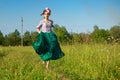 Beautiful woman in dress in nature running on the road