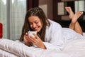 Beautiful woman dressed in a bathrobe in hotel room