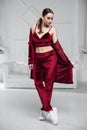 Beautiful woman dressed in a burgundy velvet suit