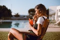 Beautiful woman drinking cocktail near the pool Royalty Free Stock Photo