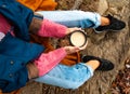 Beautiful woman drinking coffee in autumn park. Woman holding cup of coffee in the hands outdoor Royalty Free Stock Photo