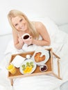 Beautiful woman drinking coffee in bed Royalty Free Stock Photo