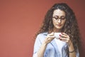 Beautiful woman drinking coffee at cafe. Portrait of young woman in a cafeteria drinking hot cappuccino. Pretty woman with