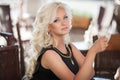 Beautiful woman drinking coffee in cafe restaurant, girl in bar, summer vacation. Pretty blond at breakfast. happy smiling woman