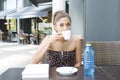 Beautiful woman drinking coffee in the terrace restaurant. Royalty Free Stock Photo