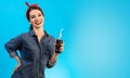 The beautiful woman drinking a cola on the blue background.