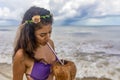 Beautiful woman drinking from a delicious coconut at a party on a Caribbean beach under a radiant sun, enjoying this party Royalty Free Stock Photo