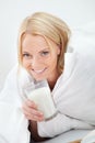 Beautiful woman drinking milk in bed Royalty Free Stock Photo