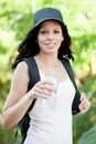 Beautiful woman drinking water while hiking Royalty Free Stock Photo