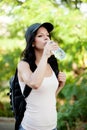Beautiful woman drinking water while hiking Royalty Free Stock Photo
