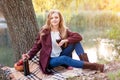 Beautiful woman drinking wine outdoors having picnic in the park. Portrait of young blonde beauty enjoying a glass of Royalty Free Stock Photo