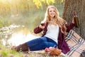 Beautiful woman drinking wine outdoors having picnic in the park. Portrait of young blonde beauty enjoying a glass of Royalty Free Stock Photo