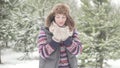 Beautiful woman drinks hot tea from a thermos in winter