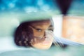 Beautiful woman driver reflecting in the rear view mirror Royalty Free Stock Photo