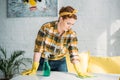 beautiful woman dusting table