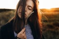 beautiful woman with ear wheat in sunlight sunset sensual portrait in summer evening field. atmospheric moment. earth day. Royalty Free Stock Photo