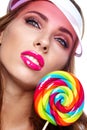 Beautiful woman eating big red lollipop in sun hat Royalty Free Stock Photo