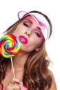 Beautiful woman eating big red lollipop in sun hat Royalty Free Stock Photo