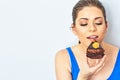 Beautiful woman eating cake. Studio portrait. Royalty Free Stock Photo