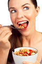 Beautiful woman eating cereal with strawberries Royalty Free Stock Photo