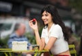 Beautiful woman eating fruit lunch out of office on city street on public place. Royalty Free Stock Photo