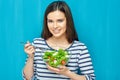 Beautiful woman eating healthy food green salad. Royalty Free Stock Photo