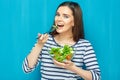 Beautiful woman eating healthy food green salad. Royalty Free Stock Photo