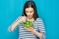 Beautiful woman eating healthy food green salad. Royalty Free Stock Photo