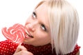 Beautiful woman eating a heart-shaped lollipop Royalty Free Stock Photo