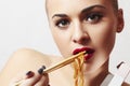 Beautiful woman are eating noodles.red lips.Chinese sticks. fast food