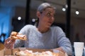 Beautiful woman eating pizza and drinking cola while sitting inside expres restaurant late at night Royalty Free Stock Photo