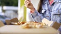 Beautiful woman eating pizza on street. Media. Woman snacking on pizza for lunch outside cafe. Young woman eats pizza on Royalty Free Stock Photo