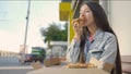 Beautiful woman eating pizza on street. Media. Woman snacking on pizza for lunch outside cafe. Young woman eats pizza on