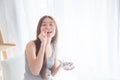 Beautiful woman eating yogurt with berries for breakfast Royalty Free Stock Photo