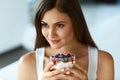 Beautiful Woman Eating Yogurt, Berries And Cereal. Healthy Diet Royalty Free Stock Photo