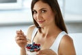 Beautiful Woman Eating Yogurt, Berries And Cereal. Healthy Diet Royalty Free Stock Photo
