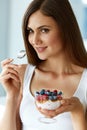 Beautiful Woman Eating Yogurt, Berries And Cereal. Healthy Diet Royalty Free Stock Photo