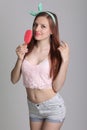 Beautiful woman eats icecream in studio