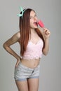 Beautiful woman eats icecream in studio