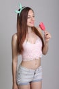 Beautiful woman eats icecream in studio