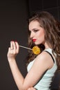 Beautiful woman eats sweet candy lollipop sweets tasty Royalty Free Stock Photo