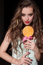 Beautiful woman eats sweet candy lollipop sweets tasty Royalty Free Stock Photo