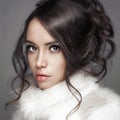 Beautiful woman with elegant hairstyle in white fur coat Royalty Free Stock Photo