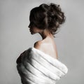 Beautiful woman with elegant hairstyle in white fur coat Royalty Free Stock Photo