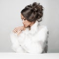 Beautiful woman with elegant hairstyle in white fur coat Royalty Free Stock Photo