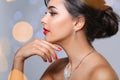 Beautiful woman with elegant jewelry on blurred background Royalty Free Stock Photo