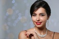 Beautiful woman with elegant jewelry on blurred background Royalty Free Stock Photo