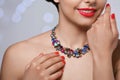 Beautiful woman with elegant jewelry on blurred background Royalty Free Stock Photo